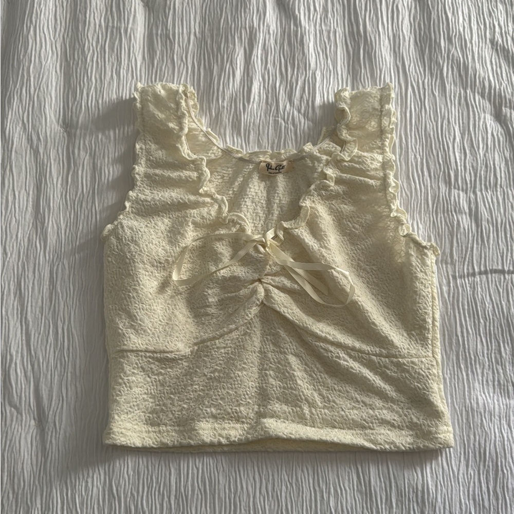 Cream cropped top with lace detailing on the front